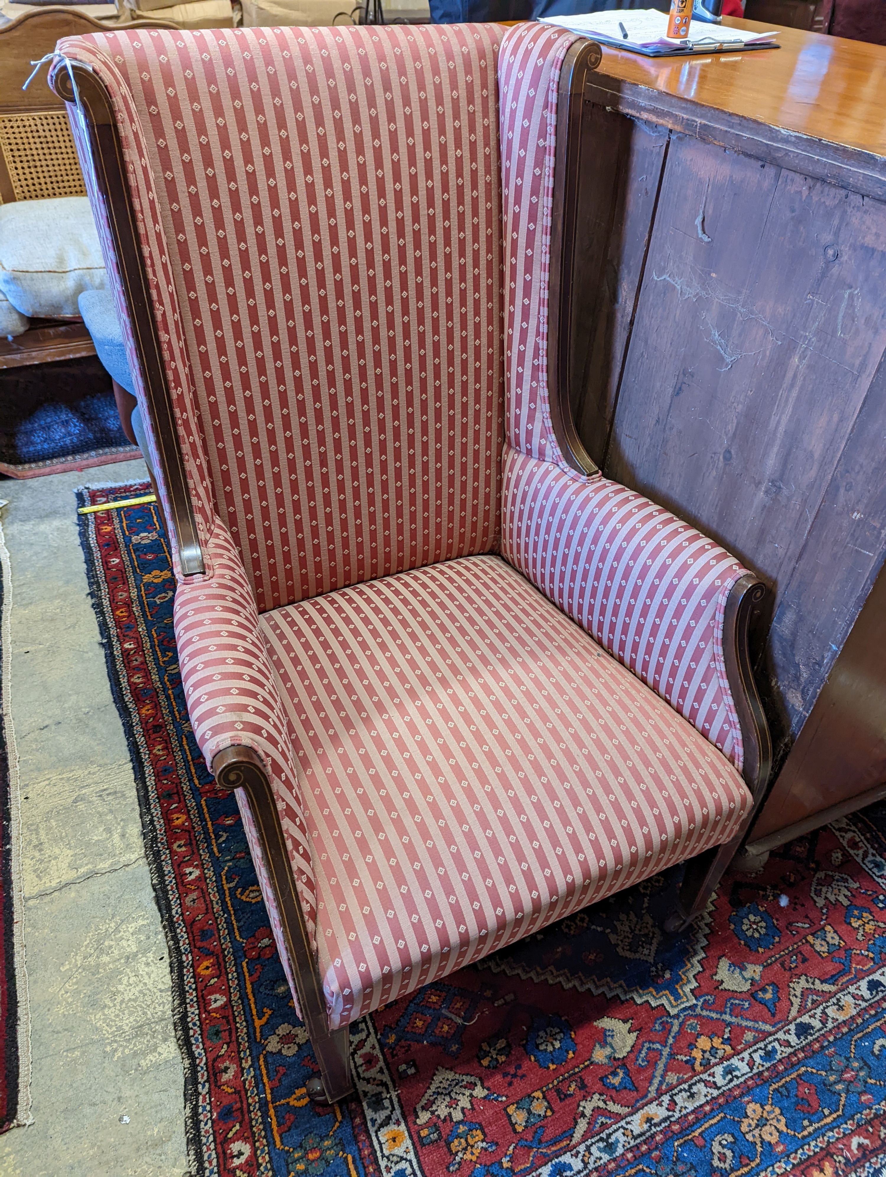 An Edwardian inlaid armchair with scrolled frame